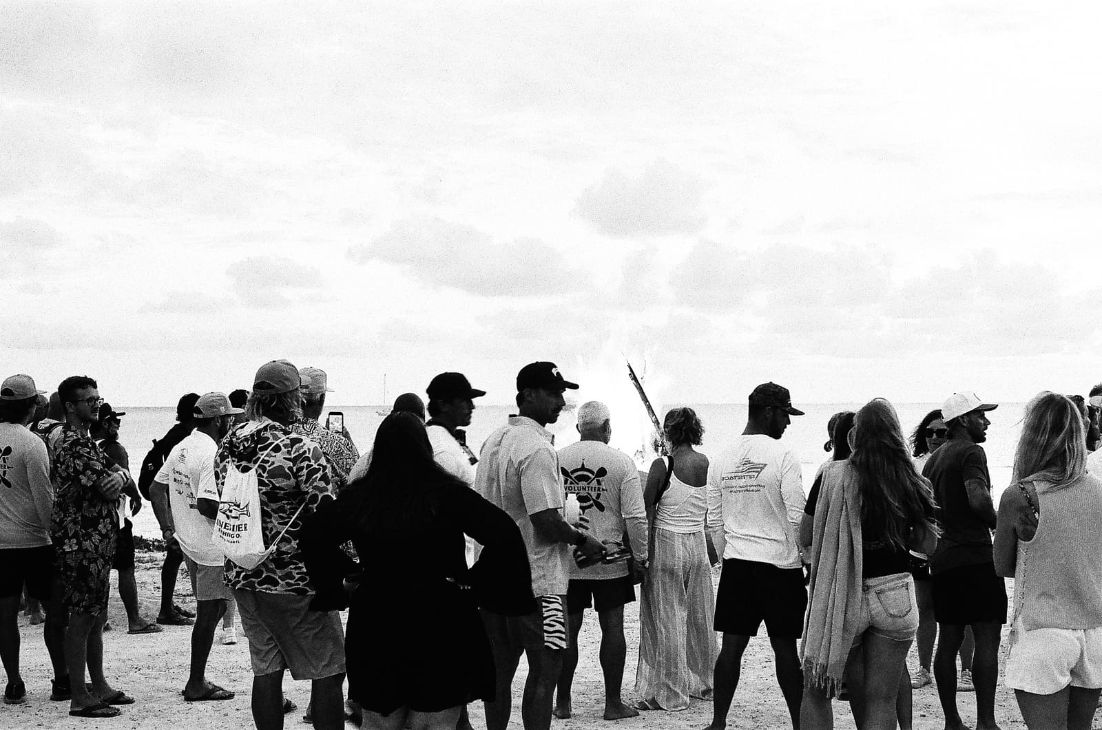 A crowd gathered on the beach at the end of The Crossing, shot in black and white on 35mm film